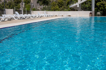 swimming pool with sun loungers in the hotel on a sunny day, family vacation