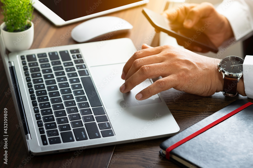 Poster close-up of man hands using keyboard of laptop computer on office desk. workspace, businessman worki