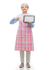 cooking, culinary and old people concept - happy smiling senior woman in kitchen apron showing tablet pc computer over white background