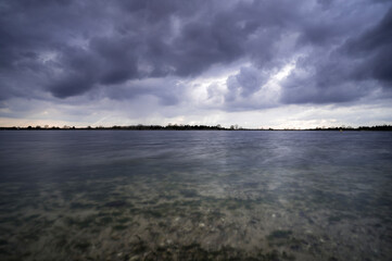 Fototapeta premium Heavy clouds over a lake