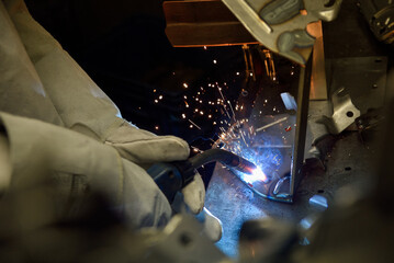 Industrial Worker labourer at the factory welding steel structure