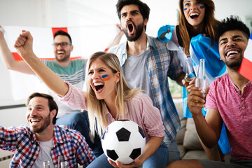 Group of multi-ethnic people celebrating football game