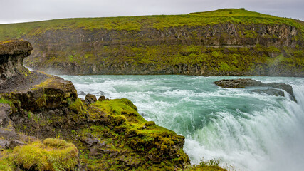 Panoramic view over waterfall wonder Gullfoss in South Iceland, Golden Circle, at summer with dramatic sky.