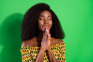 Photo of young pretty dreamy smiling positive afro girl hold hands in anticipation prayer isolated...