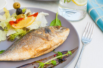 grilled Dorado with lettuce, lemon and olives