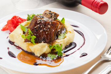 Lamb shank with mashed potato and asparagus.