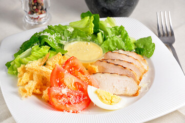 classic Caesar salad on a white plate. Concept: healthy eating