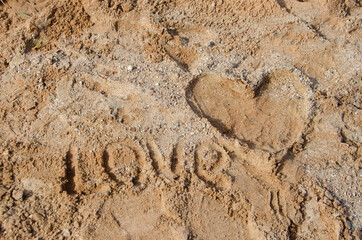 Heart on the sand and the inscription LOVE