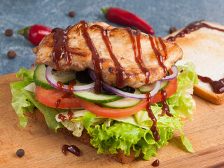 toast or sandwich with grilled chicken fillet bbq sauce and vegetables
