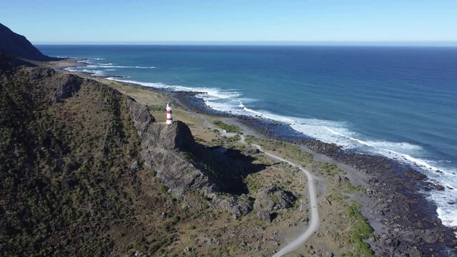 Flying towards a lighthouse, high on a cliff in Cape Palliser, New Zealand.