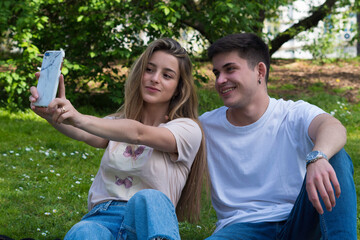 Two friends taking a selfie in a park