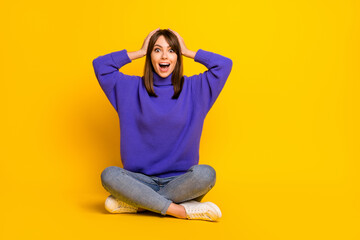 Portrait of attractive cheerful amazed girl sitting in lotus pose great news reaction isolated on bright yellow color background