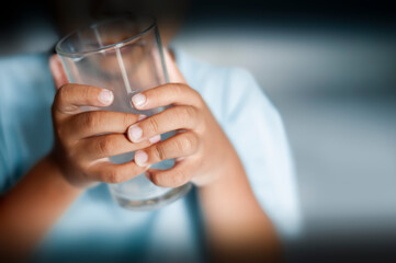 selective focus of child holding empty drinking glass