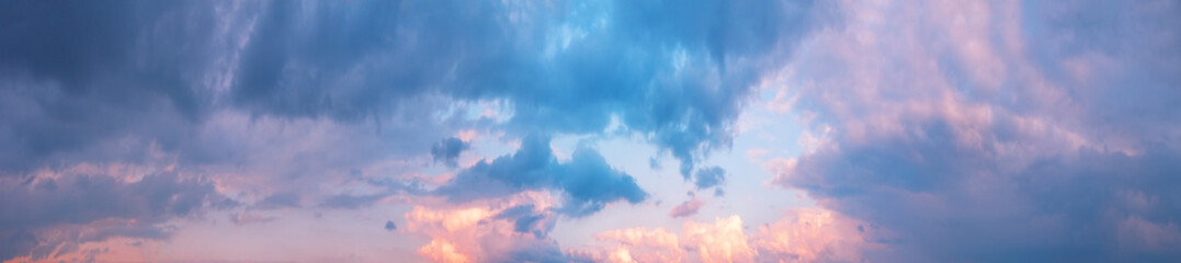 Panorama of cloudy sky with pink clouds