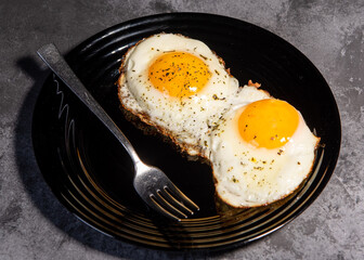 fried eggs, delicious breakfast, snack, yolk and protein food, background, top view, copy space, eat healthy raw. Scrambled eggs. Close-up