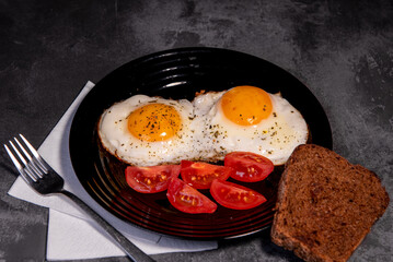 fried eggs and toast, bread, tomato, delicious breakfast, snack, yolk and protein food, background, top view, copy space, eat healthy raw materials. Scrambled eggs. Breakfast. Healthy eating. Close-up