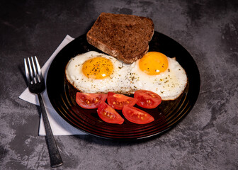 fried eggs and toast, bread, tomato, delicious breakfast, snack, yolk and protein food, background, top view, copy space, eat healthy raw materials. Scrambled eggs. Breakfast. Healthy eating. Close-up