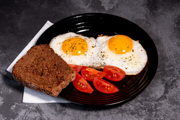 fried eggs and toast, bread, tomato, delicious breakfast, snack, yolk and protein food, background, top view, copy space, eat healthy raw materials. Scrambled eggs. Breakfast. Healthy eating. Close-up