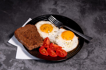 fried eggs and toast, bread, tomato, delicious breakfast, snack, yolk and protein food, background, top view, copy space, eat healthy raw materials. Scrambled eggs. Breakfast. Healthy eating. Close-up