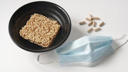 Instant noodles, surgical mask and pills, poverty during the epidemic of    Coronavirus Covid 19. Unemployment concept.