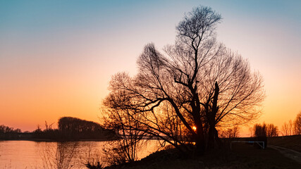 Fototapeta na wymiar Beautiful sunset with reflections near Metten, Danube, Bavaria, Germany