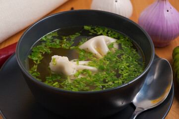 meat broth with khinkali and herbs. Georgian cuisine