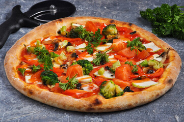 pizza with broccoli, zucchini, tomatoes and mozzarella cheese