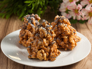 ant cake decorated with poppy seeds on a white plate