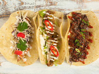 assorted tacos: chicken, beef and pork with vegetables
