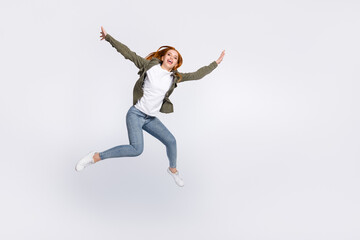 Fototapeta na wymiar Full length body size view of attractive carefree cheerful girl jumping flying isolated over gray pastel color background