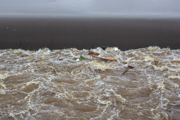 Floating garbage in the swirling water.