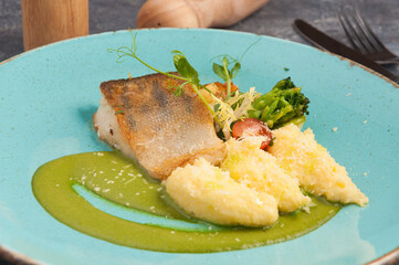 pike perch with mashed potatoes on a blue plate