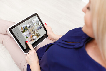 young woman sitting at modern home using smart home station.