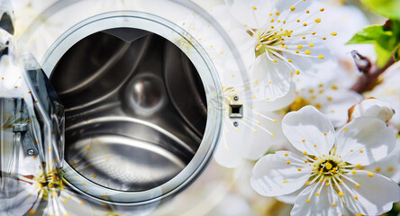 Open washing machine in spring flowers.