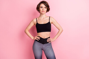 Photo of attractive charming young woman hold hands waist training regime isolated on pink color background