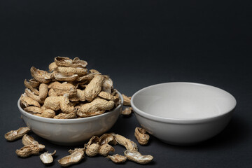 One bowl full of cracked peanut shells