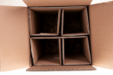 Closeup brown cardboard box with dividers. Glass bottle transport box