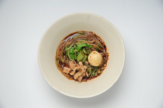 spicy thai pork noodle, boat Noodle, "Kuay Tiew Rua" with pork rind and pork Crackling