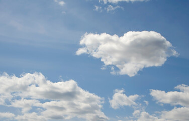 A heart-shaped cloud in the blue sky
