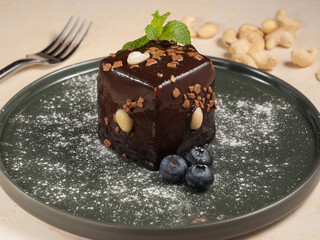 cake with chocolate and nuts in chocolate glaze