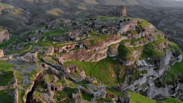 Eastern Turkey, Mesopotamia, the ancient city of Hasankeyf, caves in the rock. Aerial Drone Footage at sunset Time on the Coast of Tigres River