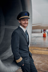 profesol confident pilot is checking plane in hangar © Yaroslav Astakhov