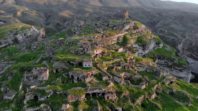 Eastern Turkey, Mesopotamia, the ancient city of Hasankeyf, caves in the rock. Aerial Drone Footage at sunset Time on the Coast of Tigres River
