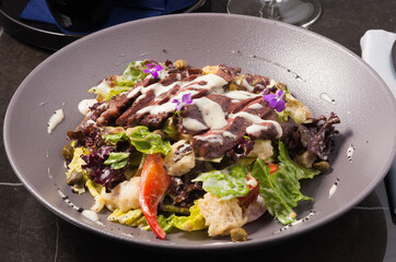 salad with steak, fresh vegetables and croutons