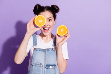 Photo of young attractive girl happy positive smile close cover eye orange fruit isolated over violet color background
