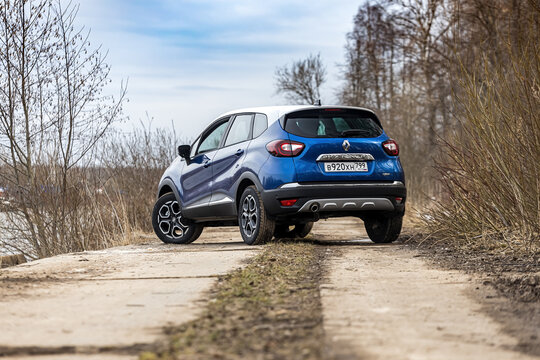 Moscow, Russia - April 11, 2021: Blue Renault Kaptur with a gray roof. The two-tone compact crossover is parked on the street near river. Backside view