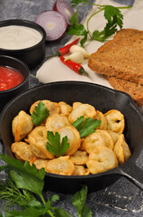 fried Russian dumplings with meat in a frying pan