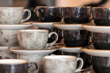 A stack of clean ceramic coffee cups and saucers. Background of empty ceramic cups. A set of cups...