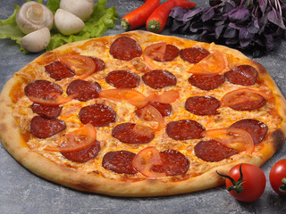 pepperoni pizza on a gray background, decorated with vegetables and mushrooms