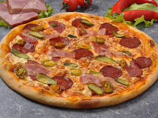 pizza with bacon, salami, pickles and jalapeno